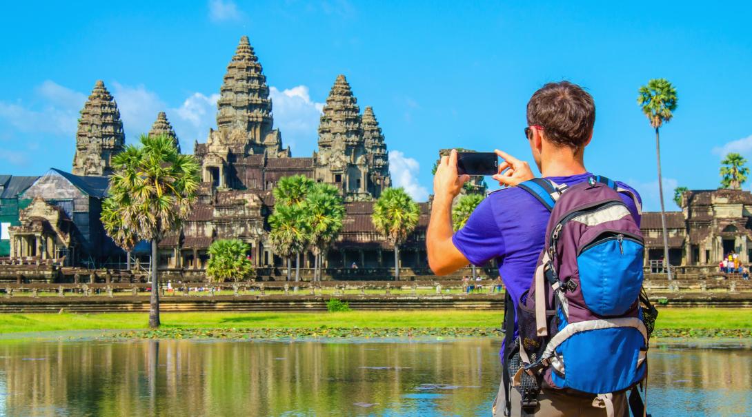 Projects Abroad volunteer explores Cambodia during his free time. Traveller takes a photo of Angkor Wat during his travels through Cambodia.